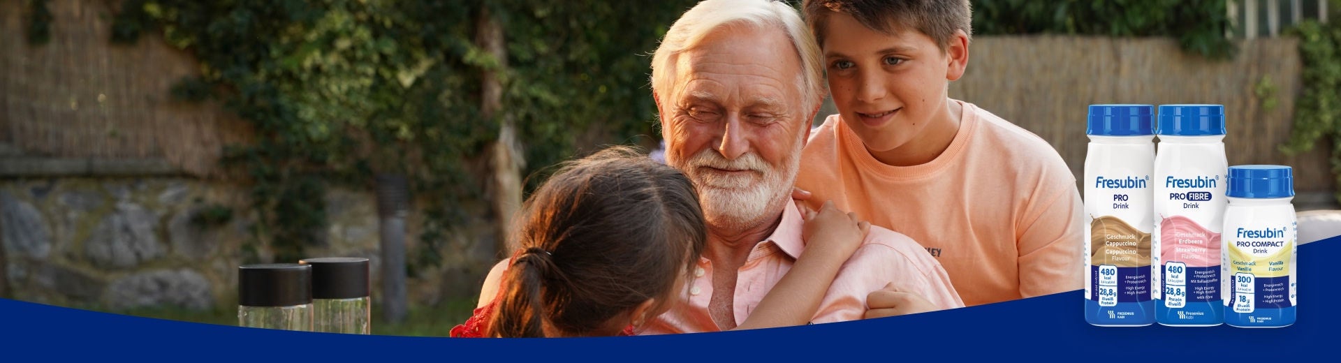 A grandpa smiles as he is spending time with his grandchildren and supported by Fresubin's PRO Range of protein supplements for older adults, including Cappuccino-flavoured PRO Drink, Strawberry-flavoured PRO FIBRE Drink and Vanilla-flavoured PRO COMPACT Drink. 