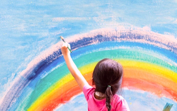 A young girl paints a rainbow on a wall thanks to the energy and nutritional support she gets from Fresubin's paediatric nutritional supplement range. 