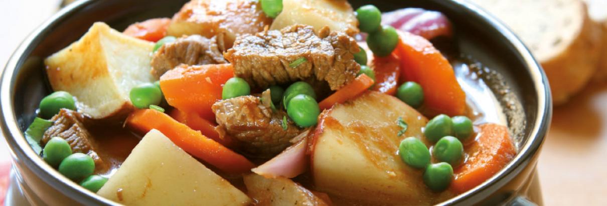 Gemüseeintopf mit Möhren, Erbsen und Rindfleisch in einer Schüssel