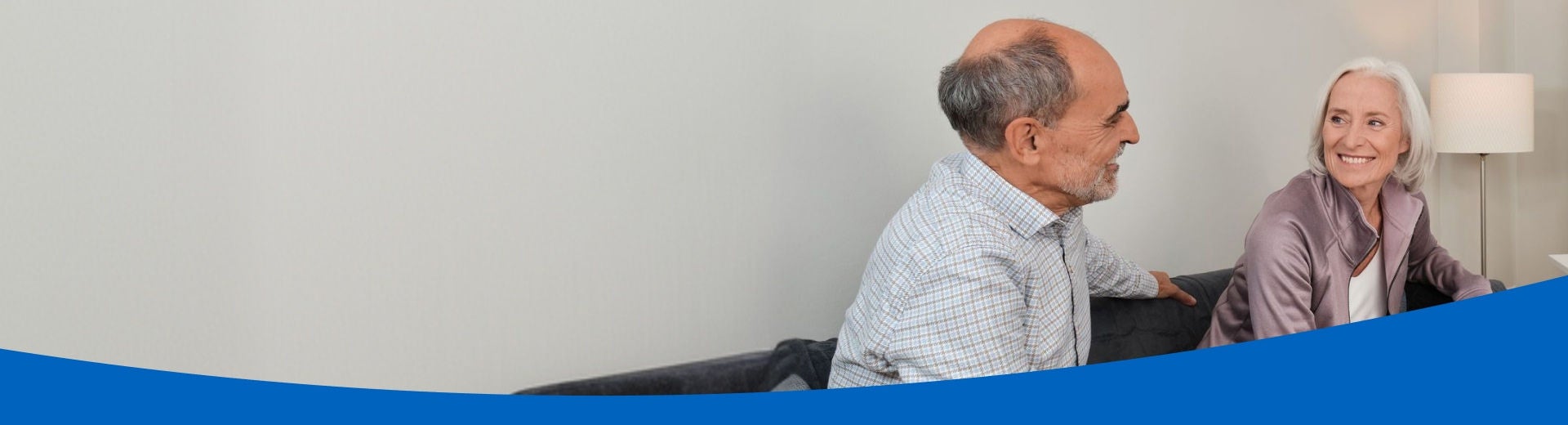 An older man and woman on a sofa smile at each other knowing they are supported by Fresbin's Tube Feed range, which includes Frebini ORIGINAL FIBRE, Fresubin ENERGY and Supportan Tube Feeds. 
