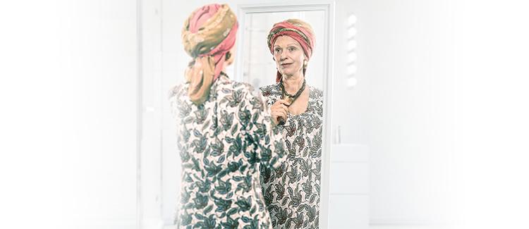 woman looking at herself in the mirror
