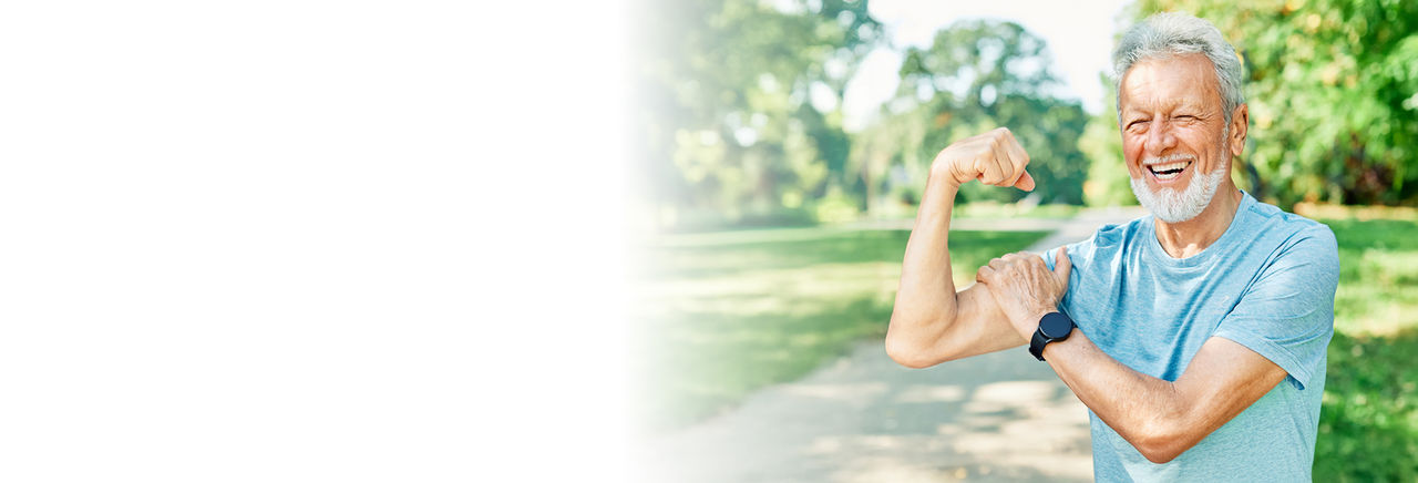 elderly man showing his muscles while jogging