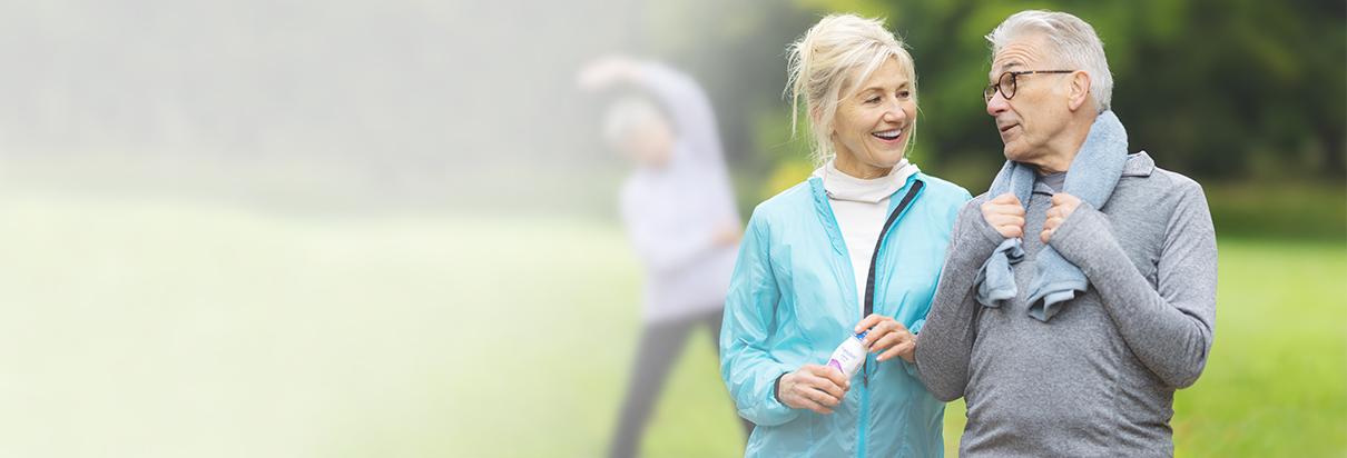 Anwendung von Fresubin: Bequem und sicher - Ältere Patientin, Freundin und Ehepartner nehmen draußen beim Sport Fresubin Trinknahrung zu sich.