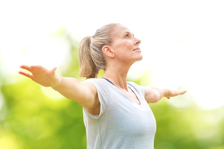 woman spreading arms in nature