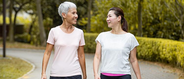 two women walking in the park 