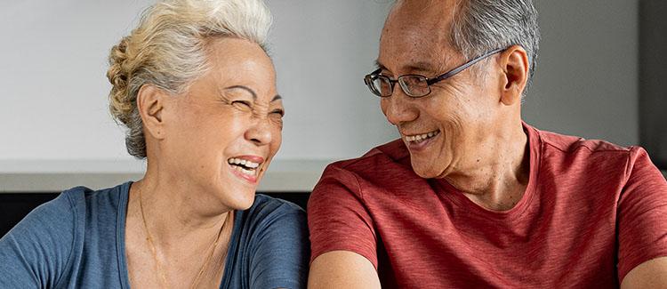 elderly couple laughing at each other
